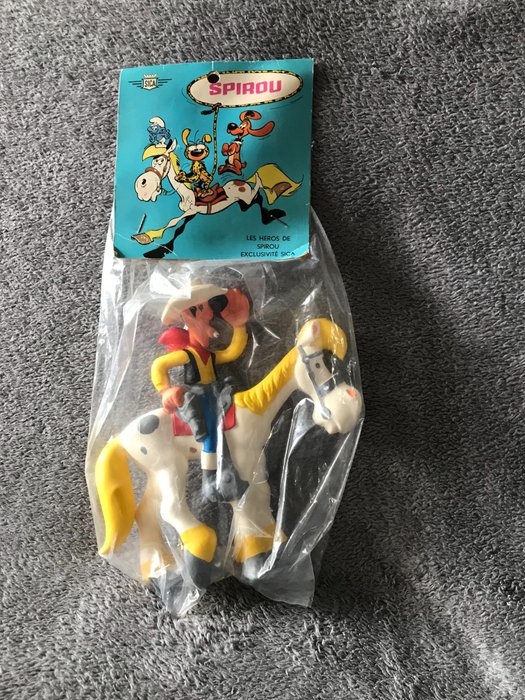 Lucky Luke - Pouêt-Pouêt en vinyle Sica-Toys - Lucky Luke sur Jolly Jumper dans l'emballage orginal de la boutique Spirou - (1964)