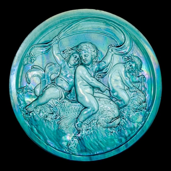 Wandbord (1) - Rococo stijl - Clément Massier large iridescent turquoise wall charger with putti riding dolphins / sea monsters