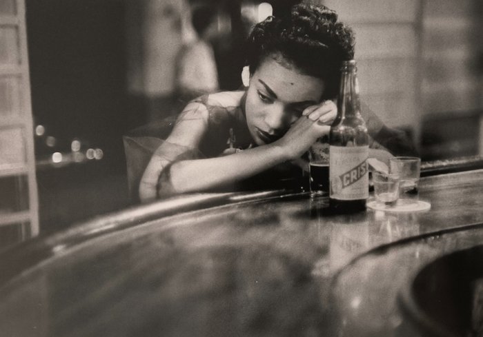 Eve Arnold - Woman at a red light district bar. Havana, Cuba. 1954.